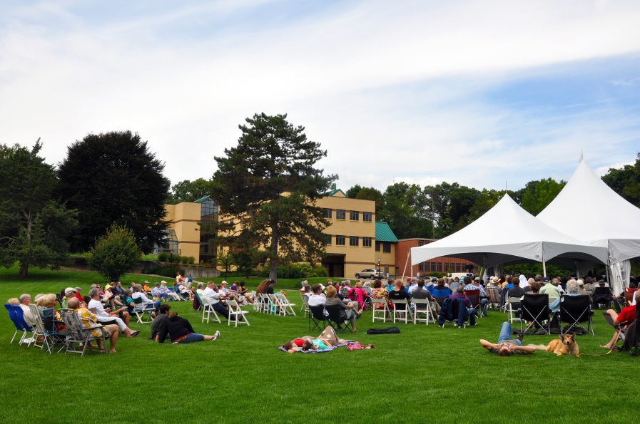 Concertgoers sit on the lawn outside the W.K. Kellogg Biological Station's Academic Building at a past Lakeside Concert.