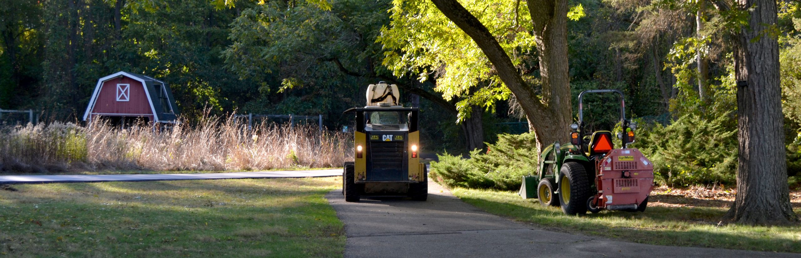 Heavy equipment sits on the Bird Sanctuary’s Paved Path, with the resident Barn Owl’s enclosure in the background.
