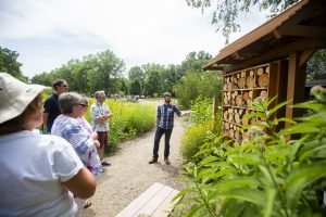 Graduate student Sean Griffin explains the bee condo