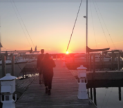 Students walk along the dock at the Gull Lake Marina at sunset.
