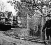 A guard stands at the gate of the W.K. Kellogg estate during the World War II years.