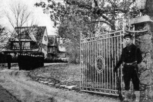 A guard stands at the gate of the W.K. Kellogg estate during the World War II years.