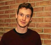 Head shot of Harry Ervin standing against a brick wall.