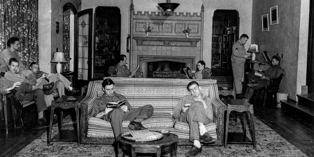 World War II soldiers relax in the living room of the W.K. Kellogg Manor House.