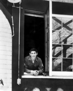 A patient at Percy Jones hospital looks out a window at the Kellogg Manor House.