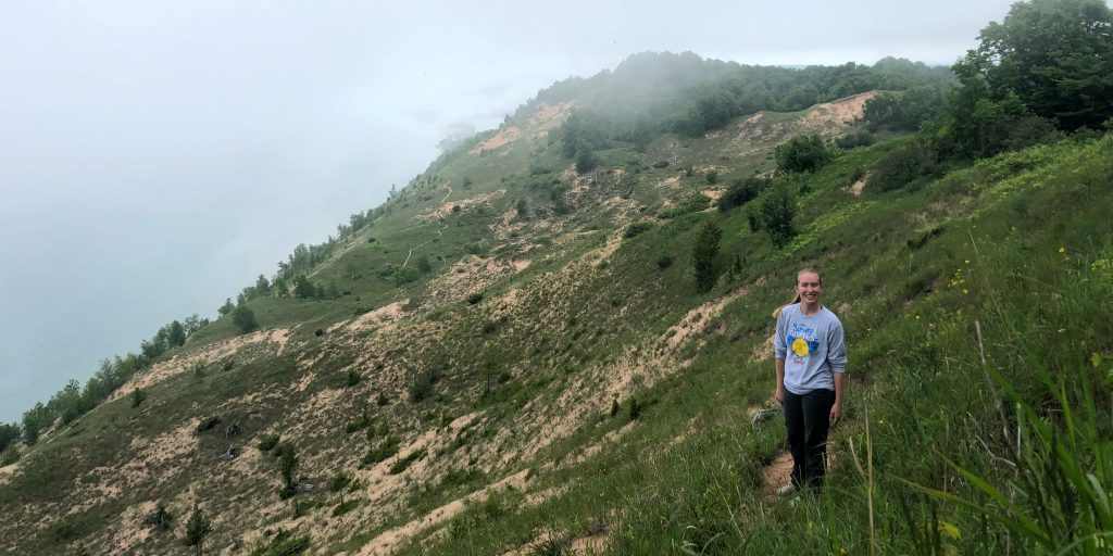 Sydney Hall pauses halfway through a climb up a large sand dune near Traverse City, Michigan.