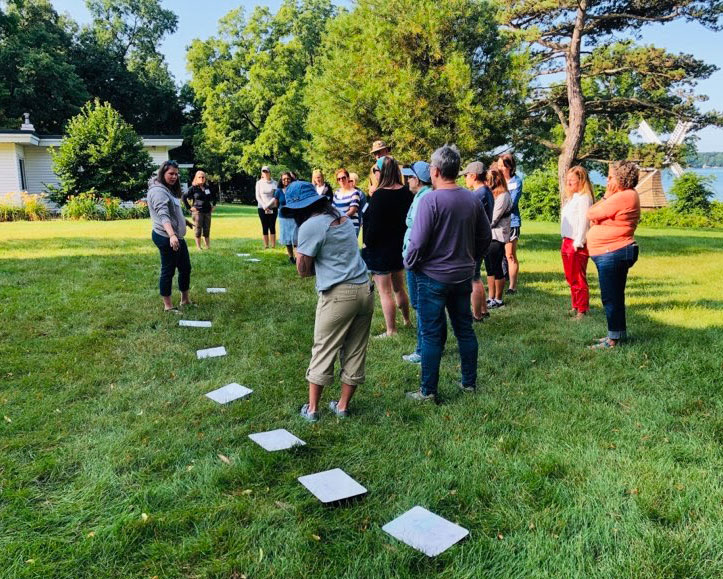 A group of educators participates in an outdoor activity.