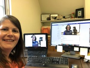 Kara Haas selfie, with dual screen showing bird of prey program