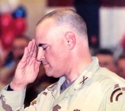 Jim Allen renders a military salute, with eyes closed, wearing tan fatigues, upon return from a tour in Iraq.