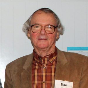 Don Hall in a plaid shhirt and brown jacket.