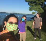 Joelyn de Lima, Elizeth Cinto Mejia and Kyle Jaynes socially distanced, masks on, standing on Windmill Island at Kellogg Biological Station, Gull Lake shore