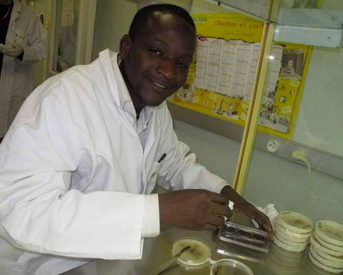 Ousseini Issaka Salia smiles while working in a lab.
