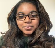 Head shot photo of Ashlynn Toles wearing an MSU T-shirt against a grey background.