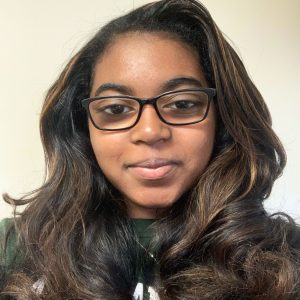 Head shot photo of Ashlynn Toles wearing an MSU T-shirt against a grey background.