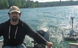 Then-graduate student Ammar Safaie navigates Gull Lake in a motorboat while measuring depths at various points in the lake. Photo credit: Phani Mantha