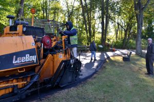 Workers put down fresh asphalt near the Sanctuary’s resident bald eagles.