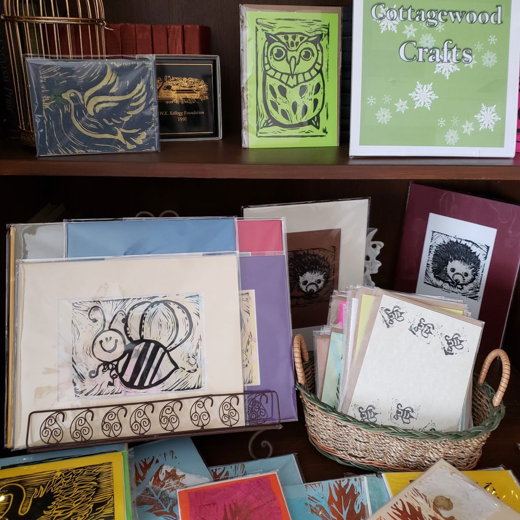 Stationery and other gifts from Cottagewood Crafts are displayed on a shelf at the W.K. Kellogg Manor House.