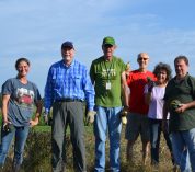 KBS volunteers stand in an agricultural field after a morning of harvesting winter squash.