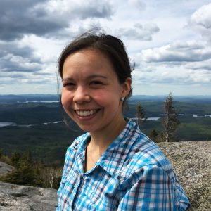 Headshot photo of Cinnamon Mittan against a mountainous backdrop.