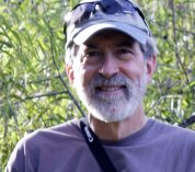 Close-up photo of Jeff Conner with plants in the background.