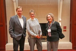 Kay Gross, center, stands with Brian Wilsey and Lynn Clark of Iowa State University.