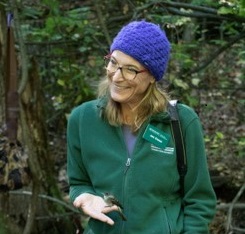 Dr. Jen Own outside in a forested area
