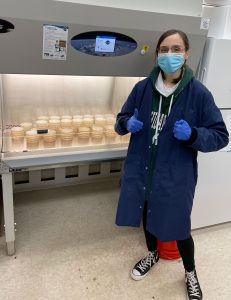 A student researcher stands by sterilizer equipment in a KBS lab.