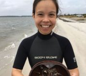 Head shot of Cinnamon Mittan standing on a beach.