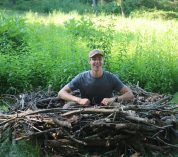 A summer 2022 KBS students sits in the eagle nest display at the W.K. Kellogg Bird Sanctuary.