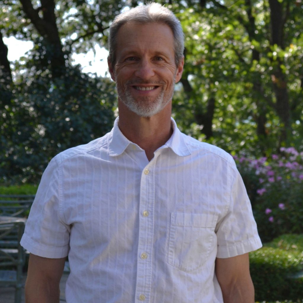 Head shot of Fredric Janzen standing near gardens at the W.K. Kellogg Manor House.