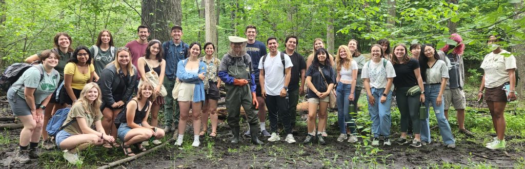 KBS summer students pose for a group photo in a forested area at the Detroit Exploration and Nature Center.