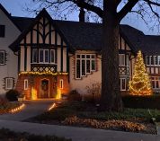 Exterior view of the W.K. Kellogg Manor House at dusk, decorated for the holidays.