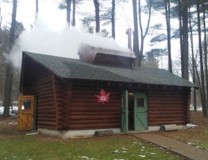 Maple Manor, the W.K. Kellogg Experimental Forest’s log-cabin maple sugar production facility, vents steam through its roof during sugaring season.