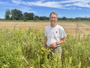 KBS LTER Director Nick Haddad stands in a prairie strip that is part of the KBS LTER. Credit: Elizabeth Schultheis.