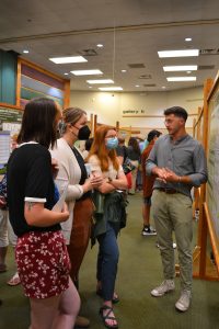 KBS Summer Student presenting research poster for guests 