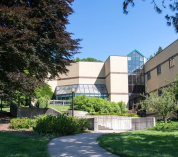 A tree-lined pathway leads to the W.K. Kellogg Biological Station Academic Building.