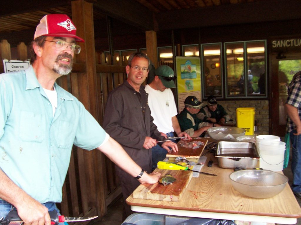 Stu Bassett and others fillet fish caught at an annual Bird Sanctuary fishing event.