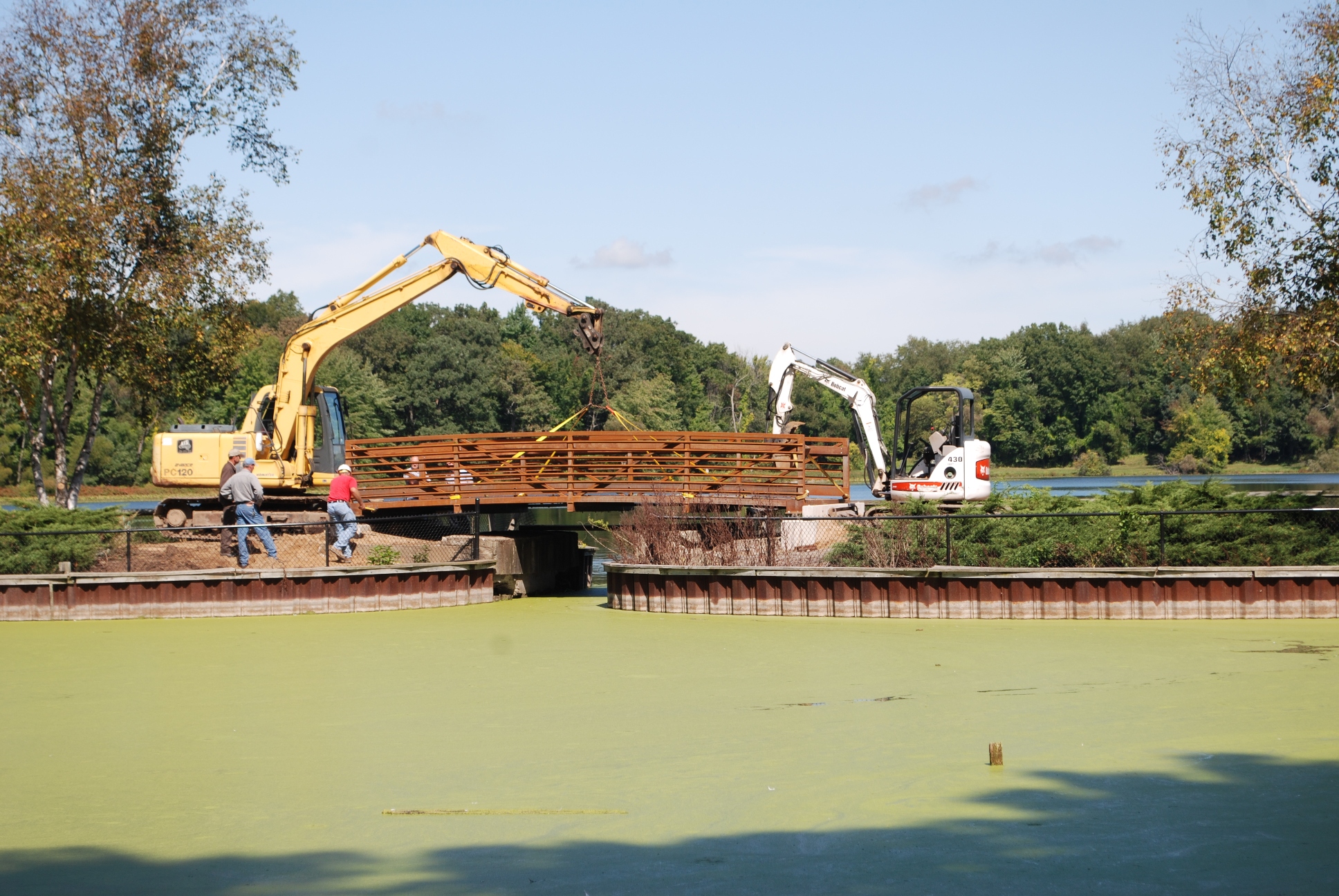Stu Bassett and crew using heavy equipment to work on the foot bridge at the Kellogg Bird Sanctuary.