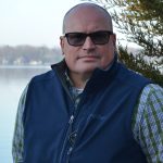 Head shot phot of Brad Osborn with Gull Lake in the background.