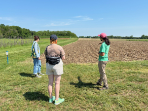 KBS staff give LTER artist-in-residence Erica Bradshaw a tour of some LTER research plots.