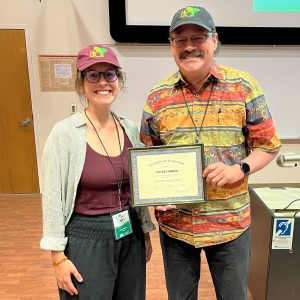 Tayler Ulbrich is presented with a certificate after being given the LTAR Early Career Scientist of the Year award.
