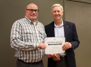 Brad Osborn stands with Dan Bollman, vice president for strategic infrastructure planning and facilities, holding a certificate for his Employee of the Quarter award.