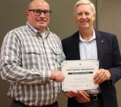 Brad Osborn stands with Dan Bollman, vice president for strategic infrastructure planning and facilities, holding a certificate for his Employee of the Quarter award.