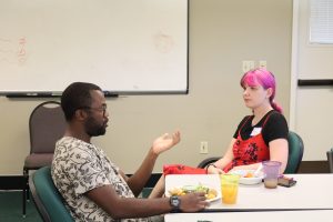 KBS and EEB faculty member Kadeem Gilbert speaks to an Envision EEB attendee at the W.K. Kellogg Biological Station.
