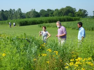 KBS K-12 Partnership participants examine a prairie strip planting at the W.K. Kellogg Biological Station.