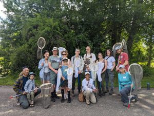 A group of participants in the 2024 KBS BioBlitz, holding insect nets with trees in the background.