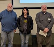 From left, Kevin Kahmark, Sierra Amyx, and Daniel Gorentz stand in the KBS Auditorium after being named Employees of the Year for 2024.