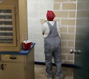 A Lowe’s volunteer paints a wall in the classroom area at the W.K. Kellogg Bird Sanctuary.