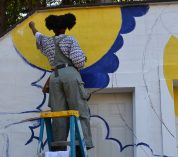 Stephanie Clark, a KBS graduate student, works on a mural titled "Complementary," which she designed and painted for the Kellogg Bird Sanctuary.