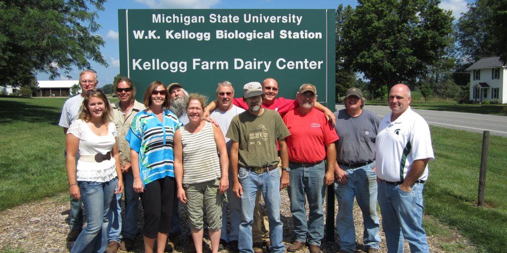 KBS Pasture Dairy Center staff pose for a group photo in front of the PDC sign.